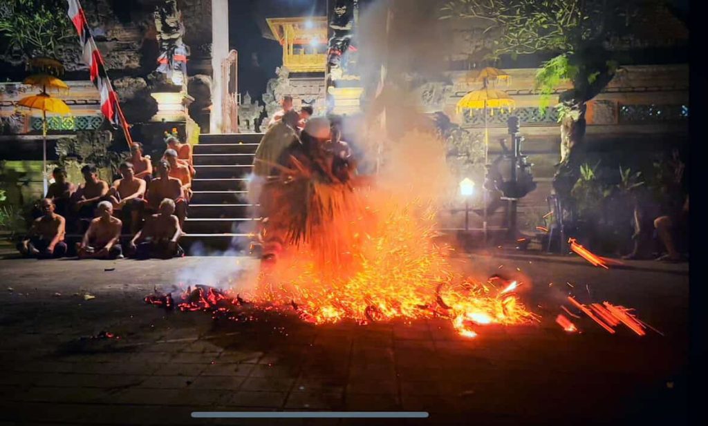 Balinese men perform a fire dance ritual at night in Bali.