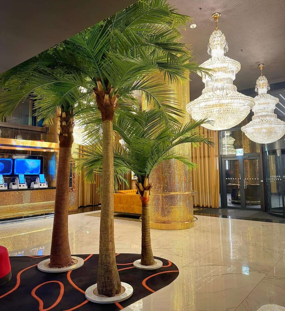 Elegant hotel lobby in Cape Town with palm trees and chandeliers