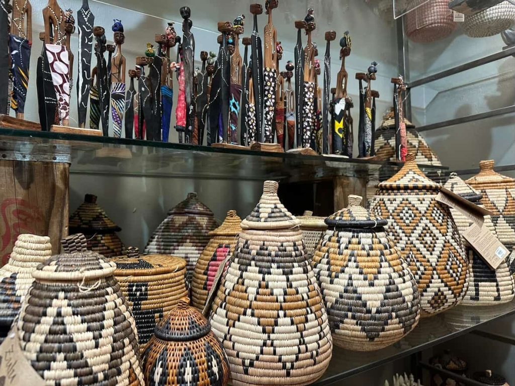 Woven baskets and African figurines on display in Cape Town shop.