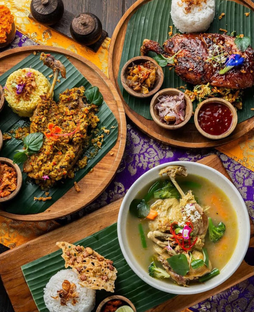 Balinese duck dishes: crispy duck, soup, and rice, served on banana leaves