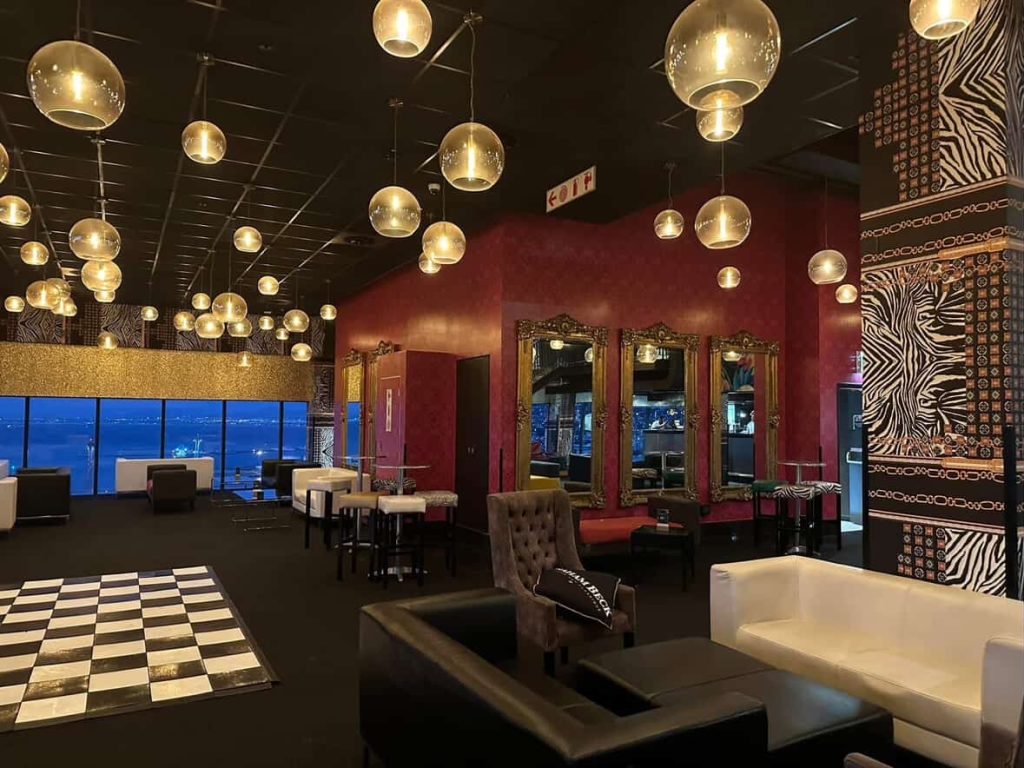Elegant lounge bar in Cape Town with city views, zebra print accents, and checkered dance floor.