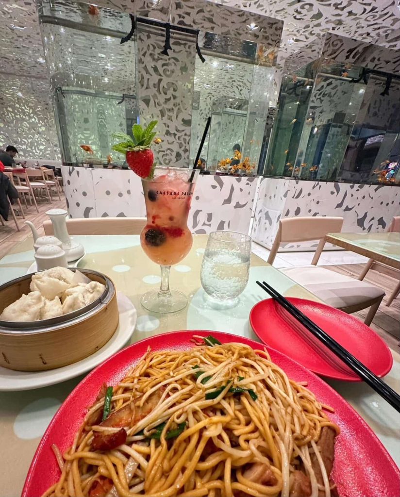 Las Vegas dining: Noodles, dumplings, and a cocktail at a restaurant with fish tank walls.