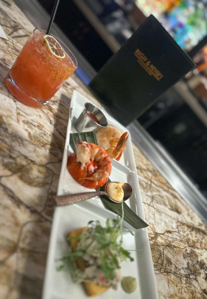 Seafood sampler with cocktail and menu at a Las Vegas restaurant.