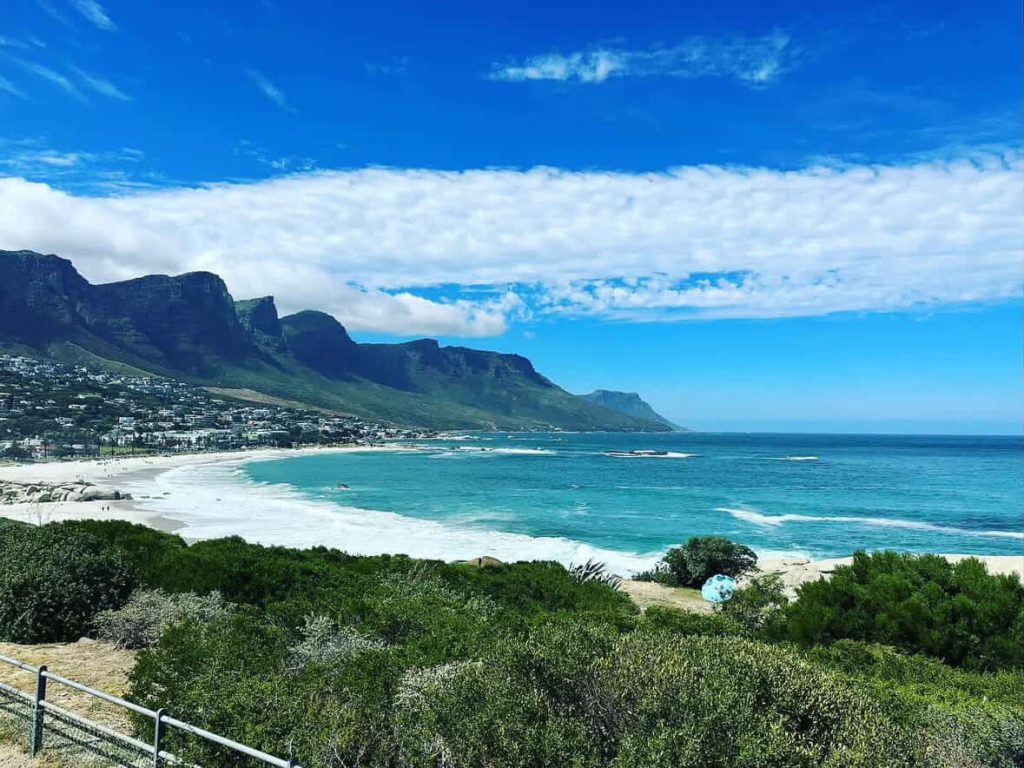 Clifton Beach, Cape Town, with Twelve Apostles mountains and turquoise ocean.