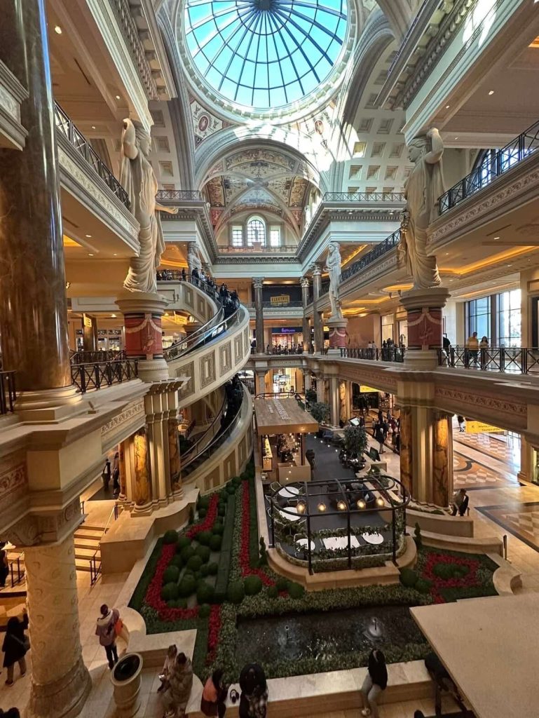 Las Vegas luxury shopping mall interior with high ceilings and statues.