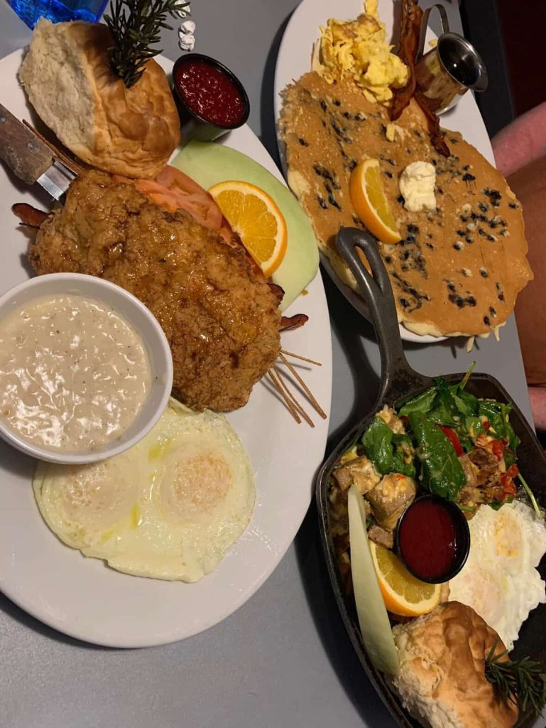 Lavish breakfast spread with chicken, eggs, pancakes, biscuits, and sides in Las Vegas.