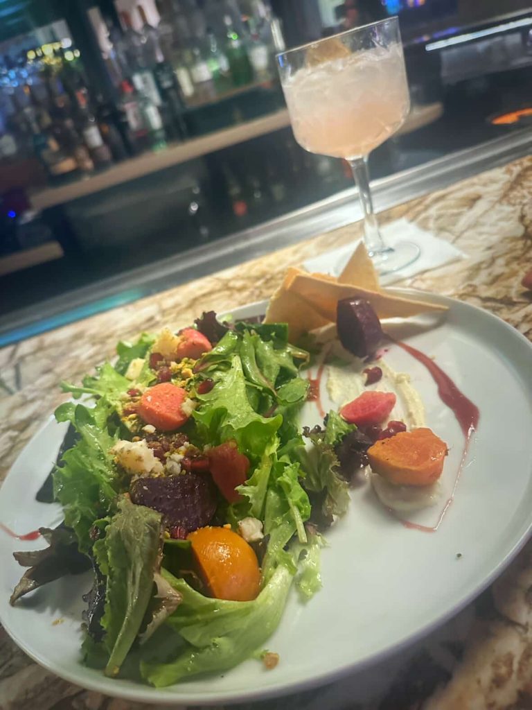 Gourmet beet salad and cocktail at a bar in Las Vegas.