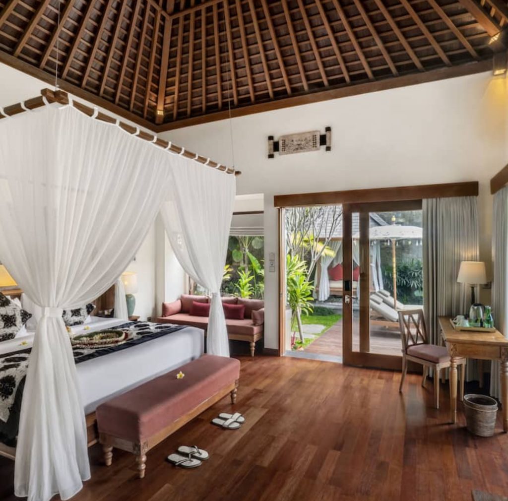Luxurious Bali bedroom with a four-poster bed and garden view