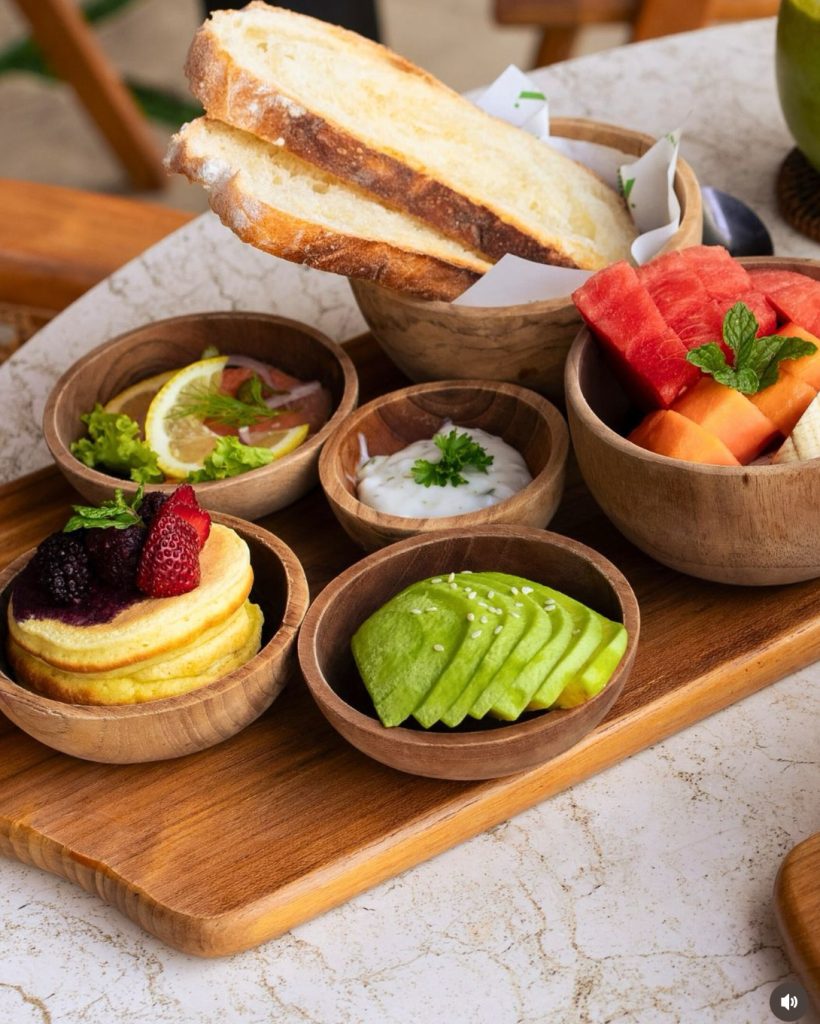 Bali breakfast spread: pancakes, fruit, avocado, toast, and yogurt