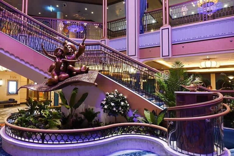 Aladdin and Jasmine statue on a Disney cruise ship staircase.