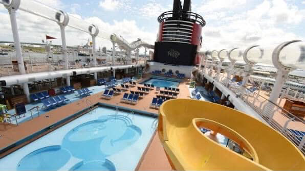 Disney cruise ship deck with Mickey Mouse pool and water slide