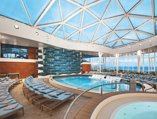 Cruise ship Solarium pool area with lounge chairs and glass dome roof.