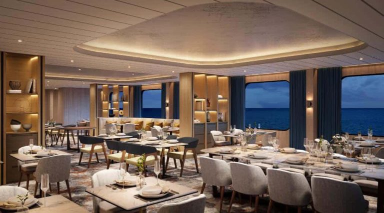 Elegant cruise ship dining room with ocean view. Tables set for dinner.