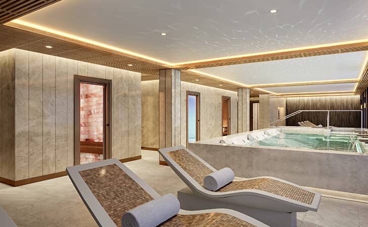 Luxury cruise spa with lounge chairs and a pool.