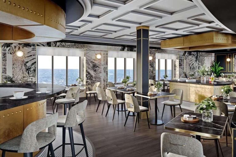 Elegant cruise ship restaurant with ocean view, stylish chairs, and modern decor.