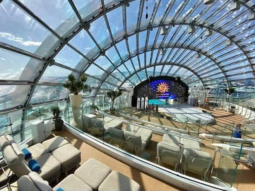 Cruise ship Solarium with glass dome and ocean view.