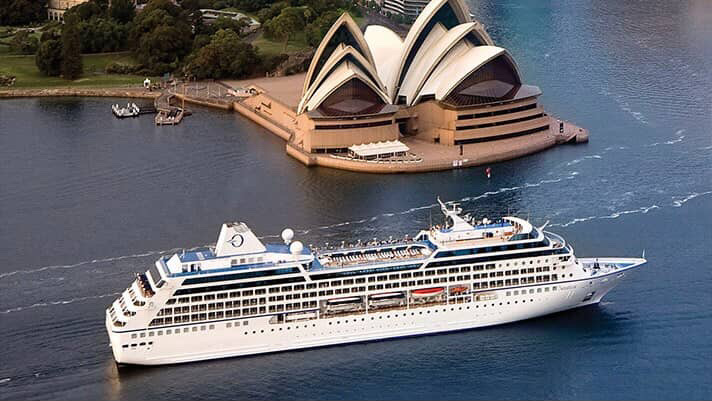 Cruise ship sailing in Sydney Harbour with the Sydney Opera House in the background.