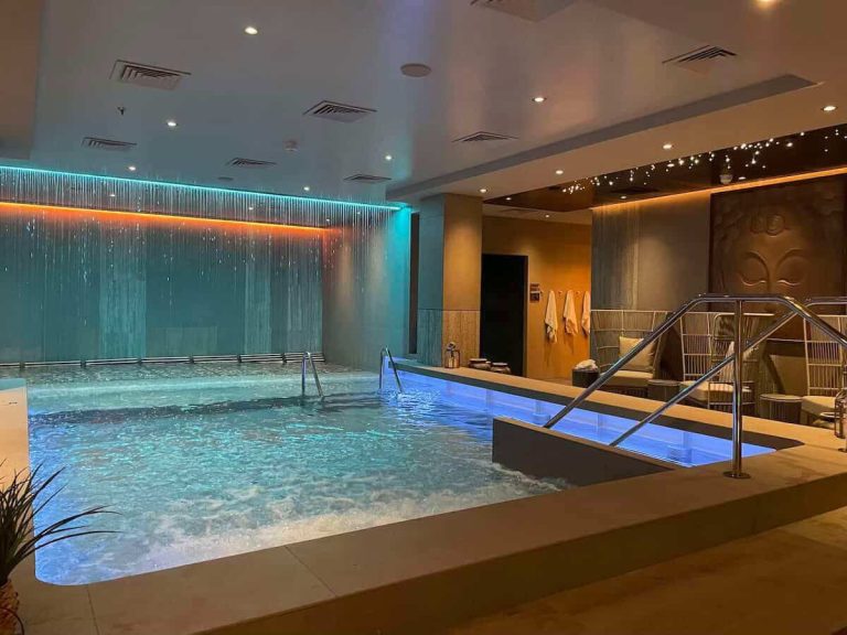 Luxury spa pool with waterfall feature and relaxing lounge area.