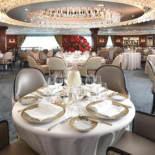 Elegant dining table set for a formal meal with floral centerpiece.