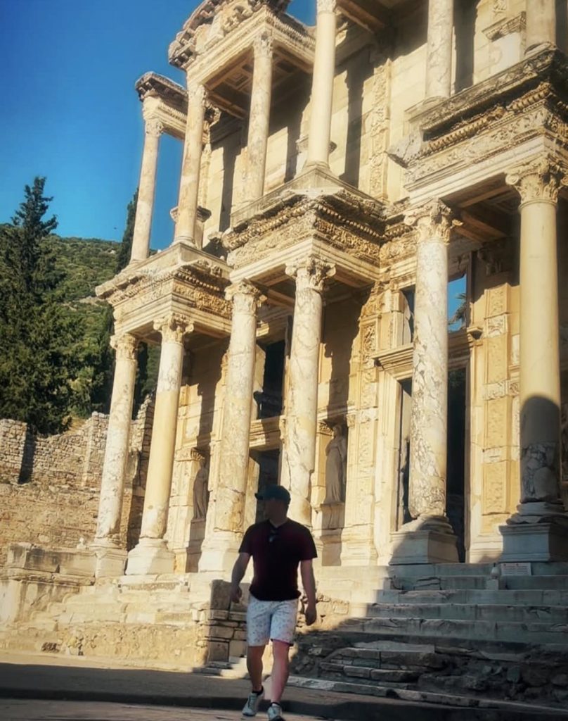 Man walks down steps of ancient Roman library in Ephesus, Turkey