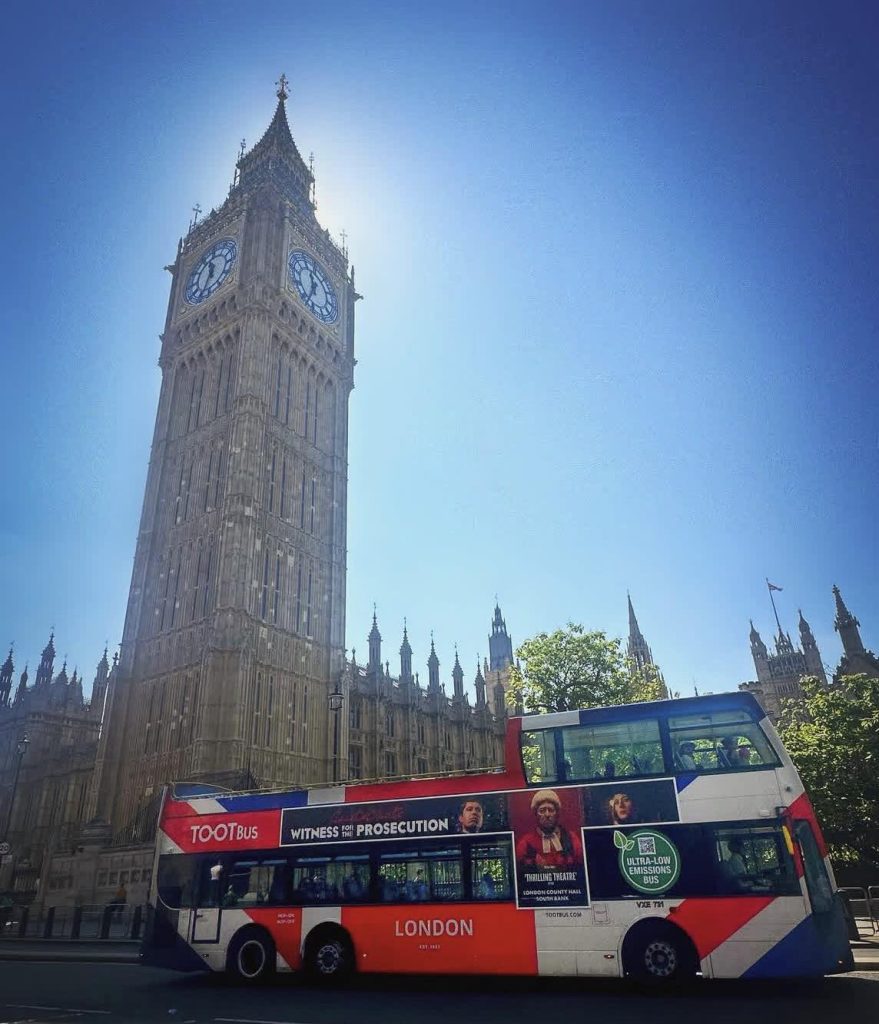 Big Ben and a Tootbus double-decker tour bus in London.