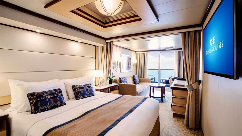 Princess Cruises suite with balcony, king bed, sofa, and ocean view