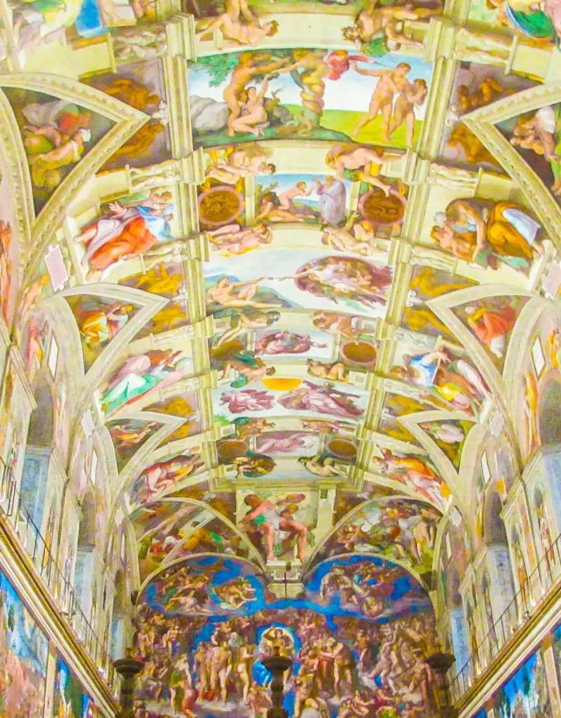 Michelangelo's Sistine Chapel ceiling frescoes depicting biblical scenes with vibrant colors.