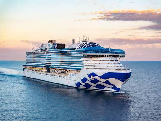 Sun Princess cruise ship sailing on the ocean at sunset